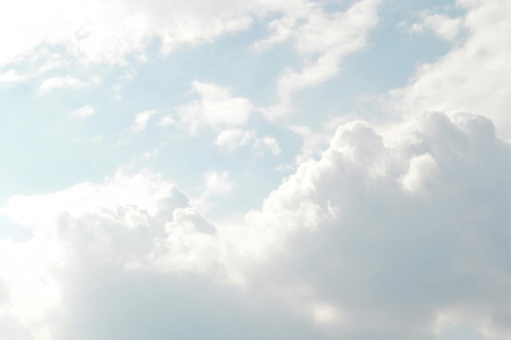 A serene view of thick, fluffy clouds set against a bright blue sky, perfect for backgrounds.